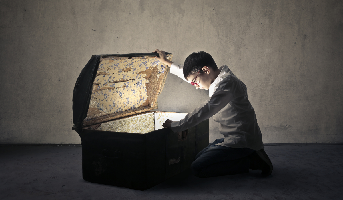 boy looking into treasure chest