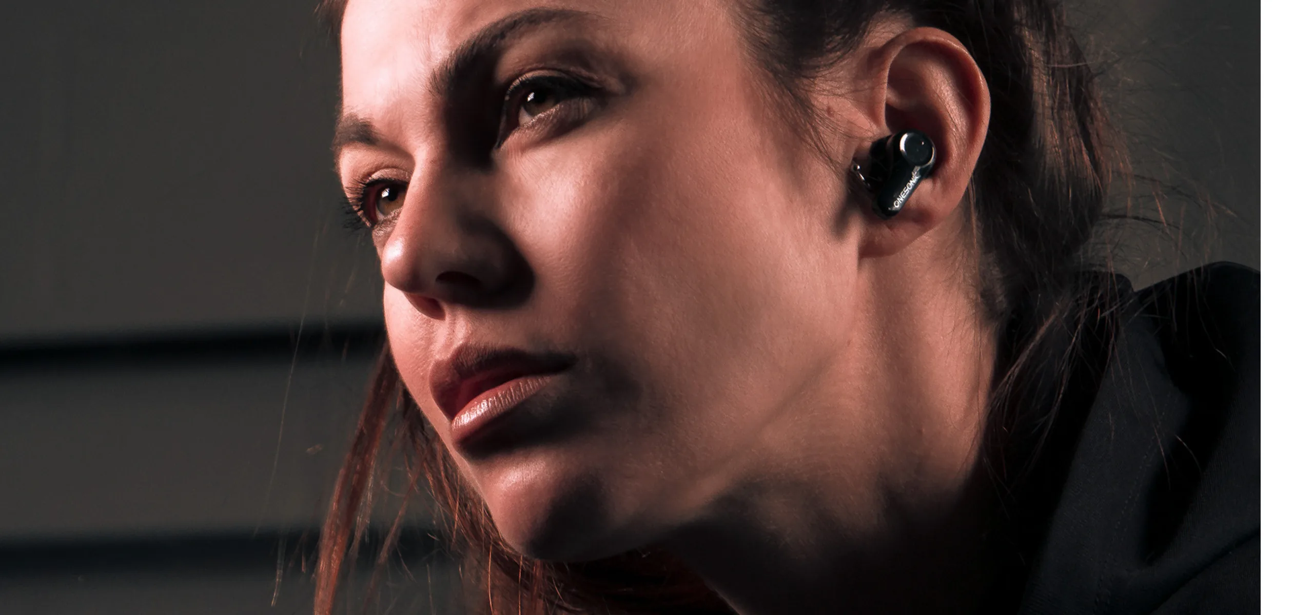 Close-up of a OneSonic wireless earbud being worn